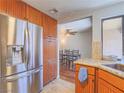 Well-equipped kitchen featuring stainless steel refrigerator and cabinetry adjacent to the dining area at 2462 Pickwick Dr, Henderson, NV 89014