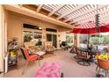 Relaxing covered patio with comfortable seating and an outdoor ceiling fan at 2521 Roseworthy Dr, Las Vegas, NV 89134