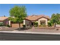 Attractive home exterior featuring a manicured front yard and a two-car garage at 2521 Roseworthy Dr, Las Vegas, NV 89134