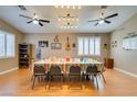 Bright dining room with a large table, modern lighting, and elegant wood floors at 2543 Farmington Ave, Las Vegas, NV 89120