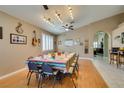 Spacious dining area featuring a long table, wood floors, and stylish lighting fixtures at 2543 Farmington Ave, Las Vegas, NV 89120