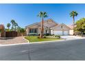 Charming single-story home with a three-car garage and well-manicured lawn and mature palm trees at 2543 Farmington Ave, Las Vegas, NV 89120