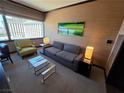 Modern living room with a comfortable gray sofa, stylish green artwork, and bright lamps at 2600 W Harmon Ave # 20034, Las Vegas, NV 89158