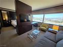 Inviting living room featuring a cozy sitting area with a sofa, armchair, desk, and city views at 2600 W Harmon Ave # 20034, Las Vegas, NV 89158