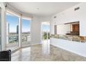 Open concept living room boasts natural light and panoramic city views with light stone flooring at 2777 Paradise Rd # 2605, Las Vegas, NV 89109