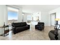 Modern living room filled with natural light from the large windows features stylish tile flooring at 2777 Paradise Rd # 2605, Las Vegas, NV 89109