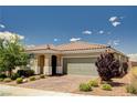 Attractive single-story home with a tile roof, two car garage and lush landscaping at 2902 Ventana Ridge Ave, Henderson, NV 89044