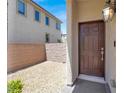 Inviting entrance with a wooden door and a decorative outdoor light fixture at 3002 Coveri Ct, Las Vegas, NV 89141