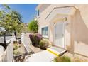 Inviting condo entrance with a secure gate, well-kept landscaping, and a welcoming walkway at 3041 Gary Cooper St # 103, Las Vegas, NV 89122