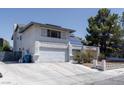 View of the home featuring two-car garage and long concrete driveway at 3061 Brockington Dr, Las Vegas, NV 89120