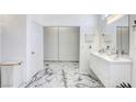 Bright bathroom featuring double sinks, a closet, and marble flooring at 3064 Azure Bay St, Las Vegas, NV 89117