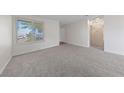 Cozy living room with neutral carpet, baseboards, and a view from the window at 317 E Van Wagenen St, Henderson, NV 89015