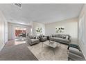 Bright living room with neutral walls, plush carpet, and contemporary furnishings, offering a comfortable and inviting space at 317 E Van Wagenen St, Henderson, NV 89015