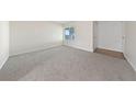 Bright living room features neutral carpet, baseboards, and a window for natural light at 317 E Van Wagenen St, Henderson, NV 89015