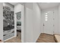 Bright entryway featuring hardwood floors, decorative wallpaper, and a modern front door at 3206 Fountaintree Ave, Henderson, NV 89044