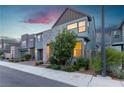 Stylish two-story home with stone accents, a modern garage door, and mature landscaping at 3206 Fountaintree Ave, Henderson, NV 89044