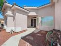 Inviting front entrance with a walkway and xeriscaping creating a low-maintenance and attractive approach to the home at 3431 Cottage Thistle Dr, Laughlin, NV 89029