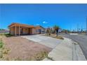Single-story house with a carport, situated on a corner lot with a clear blue sky overhead at 3630 N Pecos Rd, Las Vegas, NV 89115