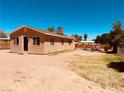 Single-story home showcasing a fenced yard, desert landscaping and clear skies at 378 W Thomas Ave, Overton, NV 89040