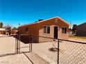 Cozy single-story home featuring a fenced yard and secure gate at 378 W Thomas Ave, Overton, NV 89040