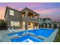 This luxury home boasts a beautiful pool, spa, tanning deck and water feature in backyard at 390 Coastal Redwood St, Las Vegas, NV 89138