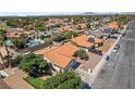 Aerial view showcasing a community with a swimming pool and houses with red-tiled roofs at 3941 Boca Grande Ave, Las Vegas, NV 89120