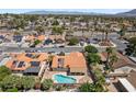 Aerial view showcasing houses with swimming pools and solar panels in a suburban neighborhood at 3941 Boca Grande Ave, Las Vegas, NV 89120
