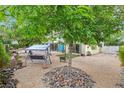 Inviting backyard featuring a swing beneath a tree and a cozy fire pit for outdoor enjoyment at 3989 Parkhaven Dr, Las Vegas, NV 89120