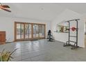 Spacious living room with tile flooring, a brick fireplace, and sliding glass doors to the backyard at 3989 Parkhaven Dr, Las Vegas, NV 89120