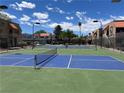 View of the community tennis and pickle ball courts, surrounded by lush landscaping and blue skies at 4121 Gannet Cir # 414, Las Vegas, NV 89103