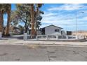 Charming home featuring a white picket fence, mature trees, and a well-maintained yard at 4186 Toronto Cir, Las Vegas, NV 89121