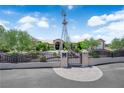 Gated entry to a well-maintained property with desert landscaping and mature trees at 4455 W Ford Ave, Las Vegas, NV 89139