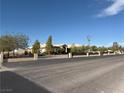 Spacious single story home featuring a circular driveway, desert landscaping, and a brick perimeter fence at 4455 W Ford Ave, Las Vegas, NV 89139
