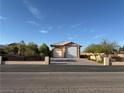 Attached garage with brick driveway, decorative fence, and desert landscaping at 4455 W Ford Ave, Las Vegas, NV 89139