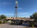Windmill on a landscaped patio area featuring desert landscape and seating at 4455 W Ford Ave, Las Vegas, NV 89139