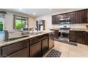 Modern kitchen with stainless steel appliances, granite countertops, and a center island at 4524 Stardusk Falls Ave, North Las Vegas, NV 89084