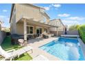 Backyard oasis showcasing a sparkling private pool, covered patio, and outdoor seating area at 4524 Stardusk Falls Ave, North Las Vegas, NV 89084