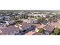 Aerial view of community with pools and palm trees, surrounded by urban cityscapes at 5000 Red Rock St # 237, Las Vegas, NV 89118