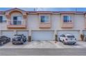 A row of townhomes features multi car garages and multiple stories with balconies at 5000 Red Rock St # 237, Las Vegas, NV 89118