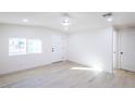 Well-lit bedroom features wood floors, a ceiling fan, and white trim for a clean, modern look at 54 E Texas Ave, Henderson, NV 89015