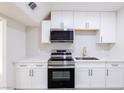 Modern kitchen features white cabinets, stainless steel appliances, and white countertops at 54 E Texas Ave, Henderson, NV 89015