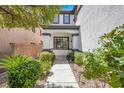 Inviting front entrance with manicured landscaping and a walkway leading to the front door at 5785 Farmhouse Ct, Las Vegas, NV 89141