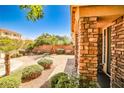 This home features an inviting front exterior with manicured shrubs and a paved driveway leading to the main entrance at 6409 Shawnee Springs Ct, Las Vegas, NV 89139