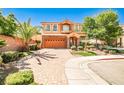 Charming two-story house with a brick driveway and well-maintained landscaping, creating a welcoming curb appeal at 6409 Shawnee Springs Ct, Las Vegas, NV 89139