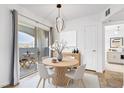 Charming dining area with sliding glass doors that lead to a balcony at 6955 N Durango Dr # 3089, Las Vegas, NV 89149