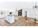 Open-concept living and kitchen area with hardwood floors, fireplace, and island at 811 Spyglass Ln, Las Vegas, NV 89107