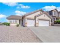 Charming desert home featuring a two-car garage and landscaped front yard at 82 Autumn Day St, Henderson, NV 89012