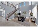 Elegant dining room with soaring ceilings, staircase, and ample natural light at 8268 Nelson Ridge Ln, Las Vegas, NV 89178