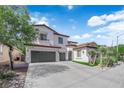 Charming two-story home with three-car garage and beautiful desert landscaping at 8268 Nelson Ridge Ln, Las Vegas, NV 89178