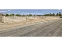 Gated horse property with white fencing and a brick column entry at 8440 La Cienega St, Las Vegas, NV 89123